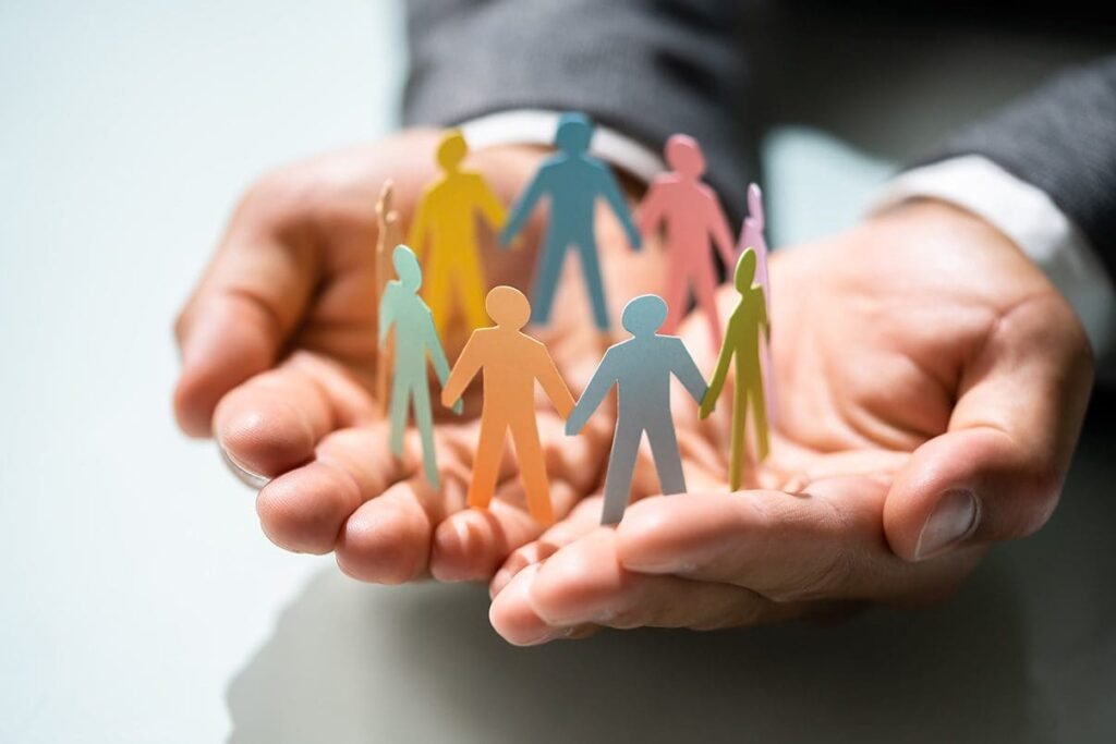 Business professionals holding cut-out paper figures, symbolizing teamwork and collaboration in a corporate environment.