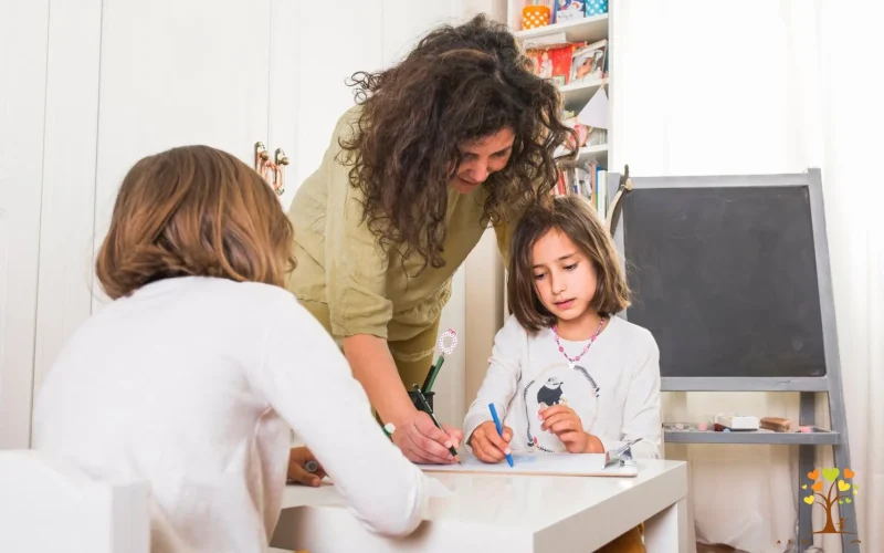 A woman collaborates with two children on a creative project, showcasing teamwork and engagement in their activity.