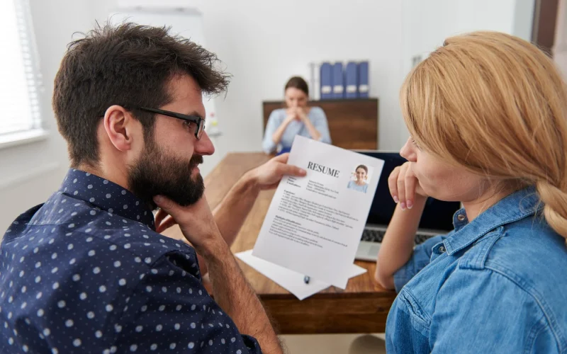Two professionals discussing a resume during a job interview.