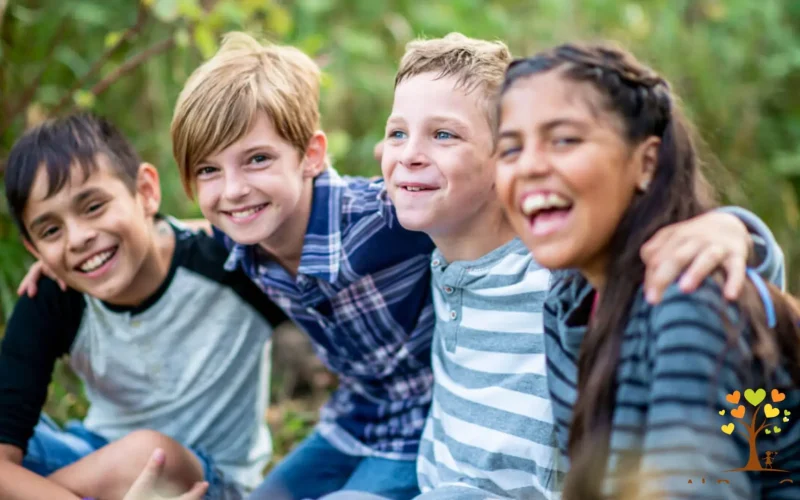 Building Stronger Connections Four smiling children sitting on the grass, embodying joy and connection in a vibrant outdoor setting.