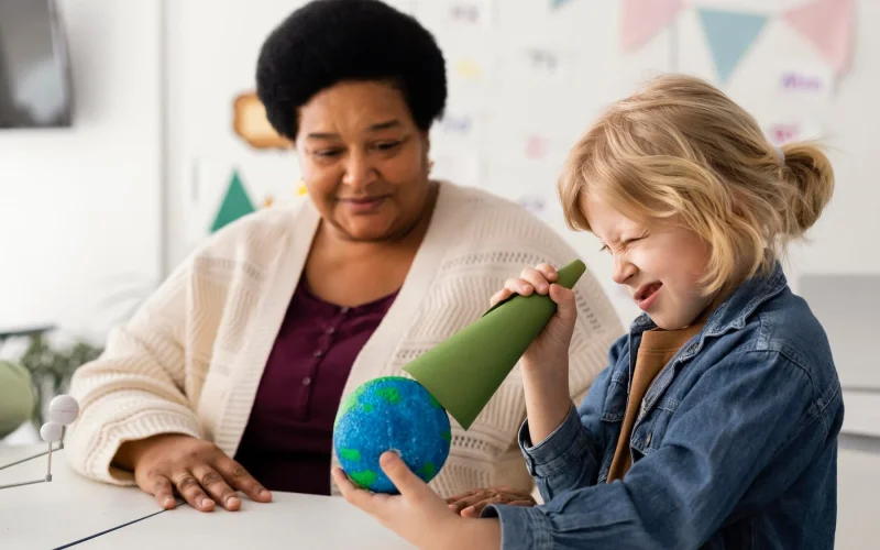 Promoting Multilingual Skills and Inclusion Child and adult engaged in a playful learning activity with a globe.